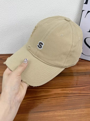 Tan baseball cap with distressed details and embroidered S logo