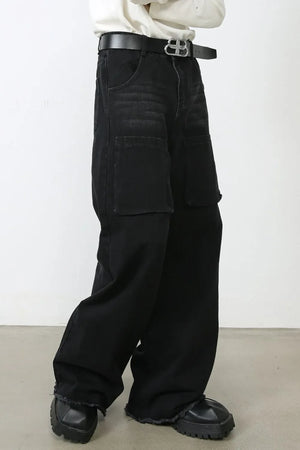 Dark wide-leg denim cargo pants with frayed hems and large front pockets.