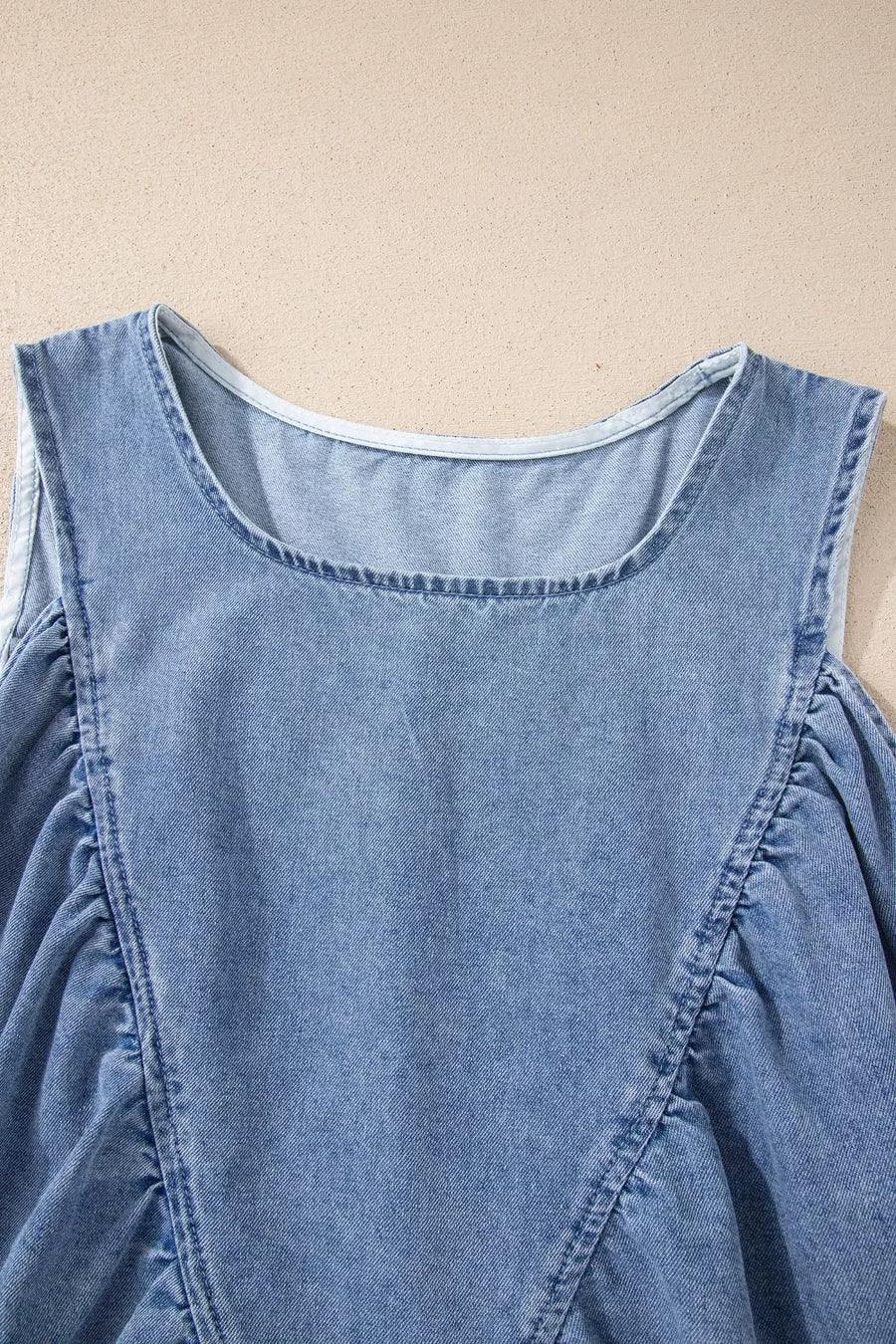 V-neck pleated denim sleeveless top with a casual cut.