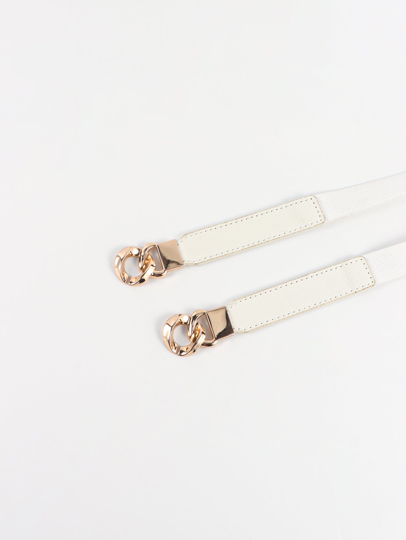 White faux leather belt with gold chain detail and gold buckle accent