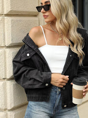 Black denim trucker jacket with button front, chest pockets, and relaxed fit.