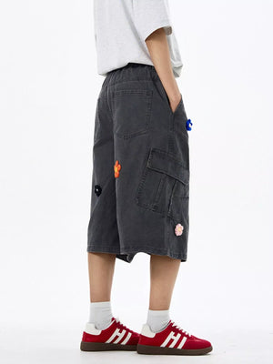 Dark Gray cotton cargo shorts with floral appliques and wide legs.