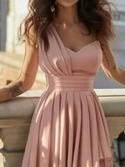 Dusty pink asymmetrical one-shoulder dress with cinched waist and pleated skirt.