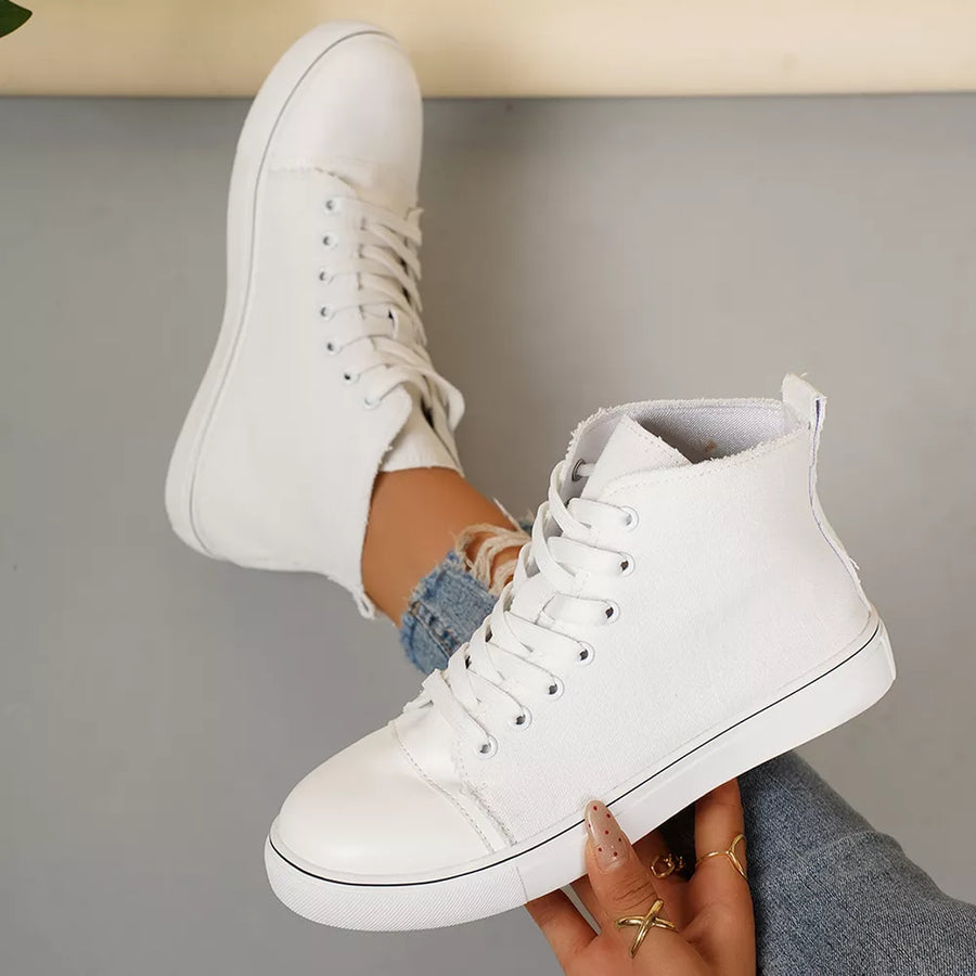 White high-top lace-up sneakers with frayed canvas detail and rubber toe cap.