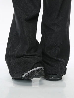 Dark denim palazzo trousers with distressed hem detail.
