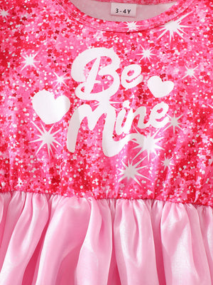 Baby dress with glitter print, "Be Mine" text, and pink organza skirt.