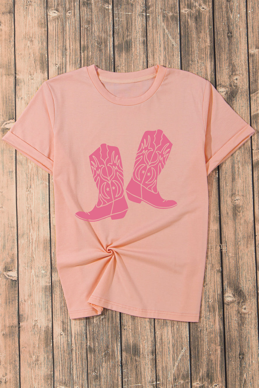 Blush pink graphic tee with round neck and cowboy boot print