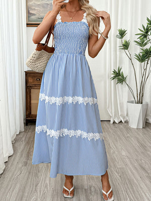 Blue striped midi dress with smocked bodice and white lace trim.