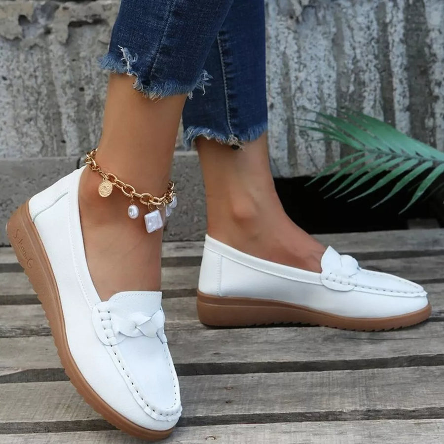 flats in white featuring round toe and low-profile fit