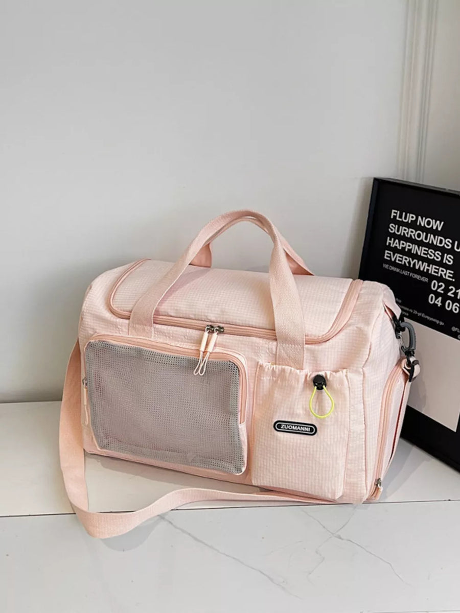 Pink duffel bag with mesh pocket and adjustable strap