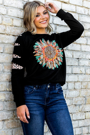 Black sweatshirt with sunflower graphic and cutout sleeves with leopard print detail.