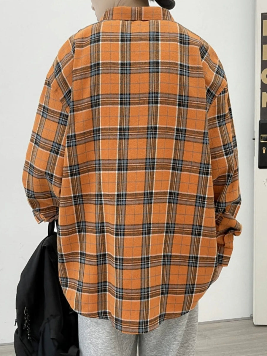 Orange plaid long-sleeve button-up shirt with a cotton blend, styled casually.