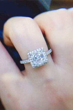Silver Asscher cut moissanite halo ring with sparkling pavé band.