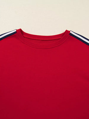 Red sweatshirt with varsity stripe detail on shoulders