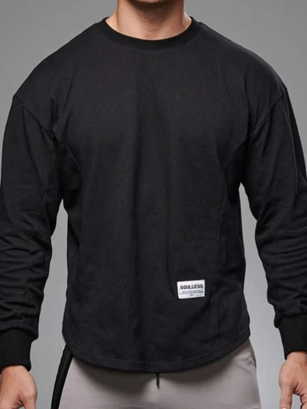 Black oversized long sleeve tee with curved hem and crew neck.