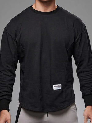 Black oversized long sleeve tee with curved hem and crew neck.
