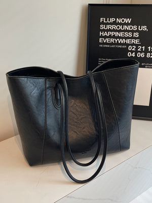 Black crinkled PU leather tote bag with twin shoulder straps and a structured shape.