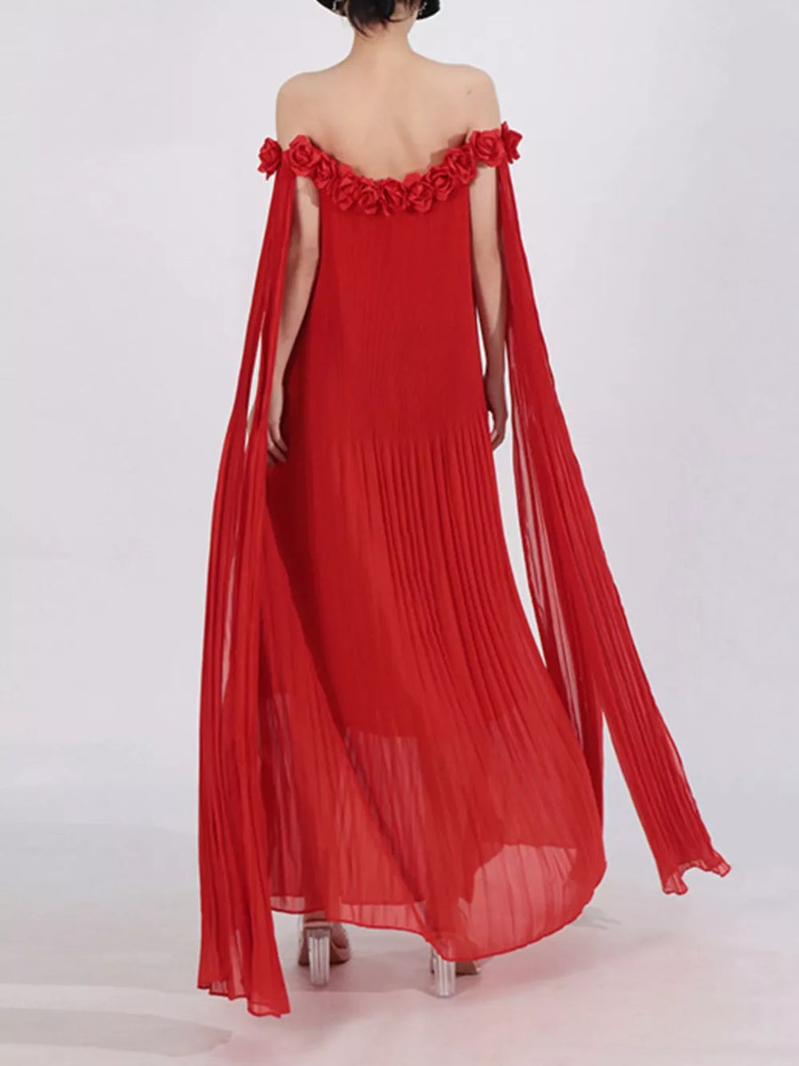 Red off-shoulder maxi dress with floral applique neckline and cape sleeves.