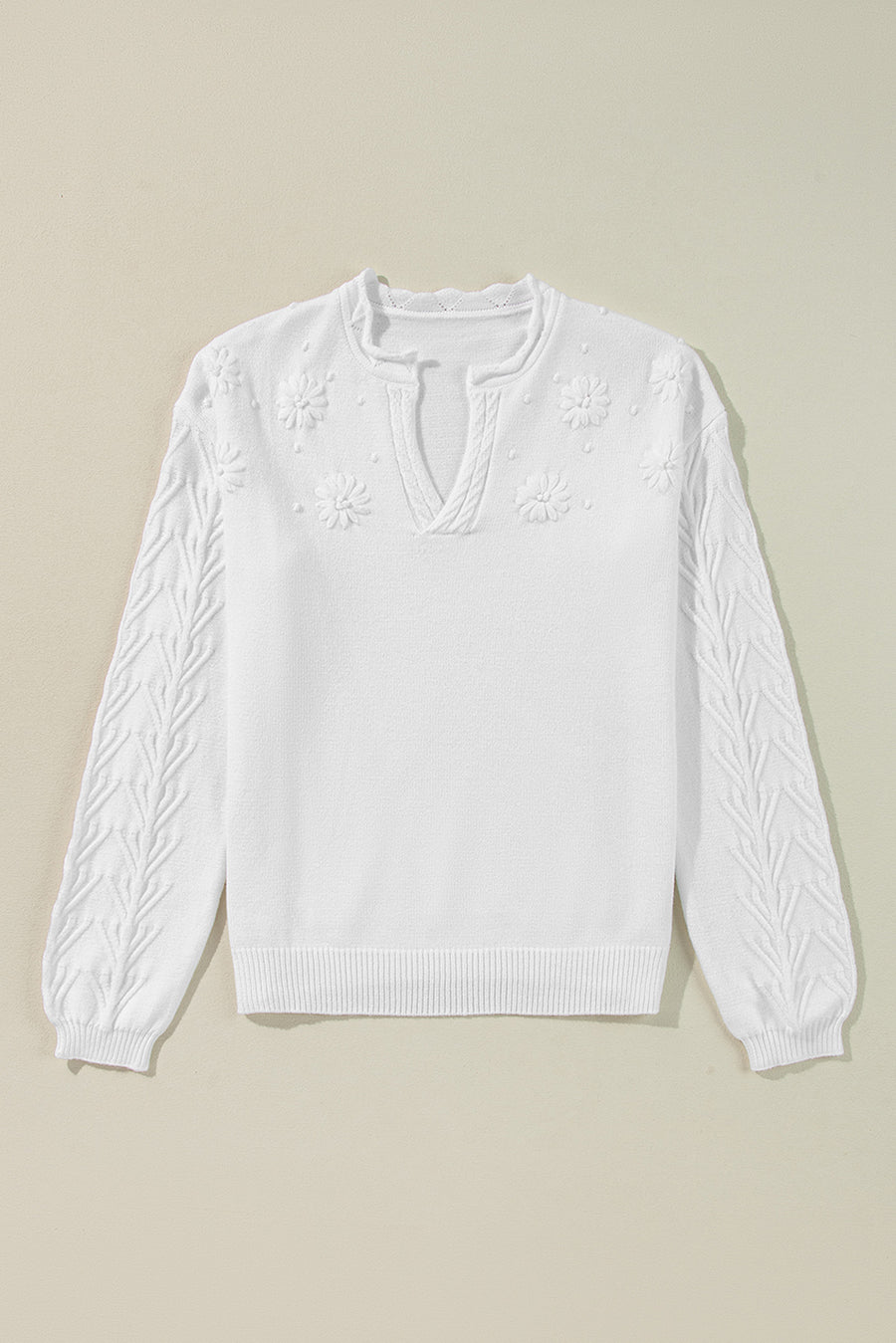 White sweater with floral embroidery and textured sleeves