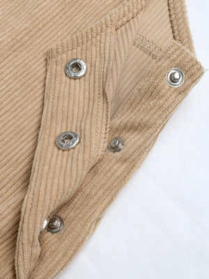 Tan corduroy overall dress detail showing snap closures