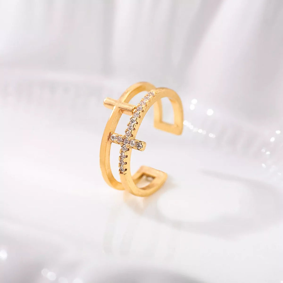 Golden open ring with rhinestone cross detail, 18K gold-plated.