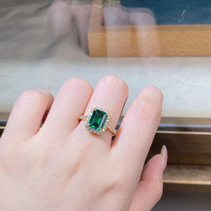 gold ring featuring geometric stone and geometric