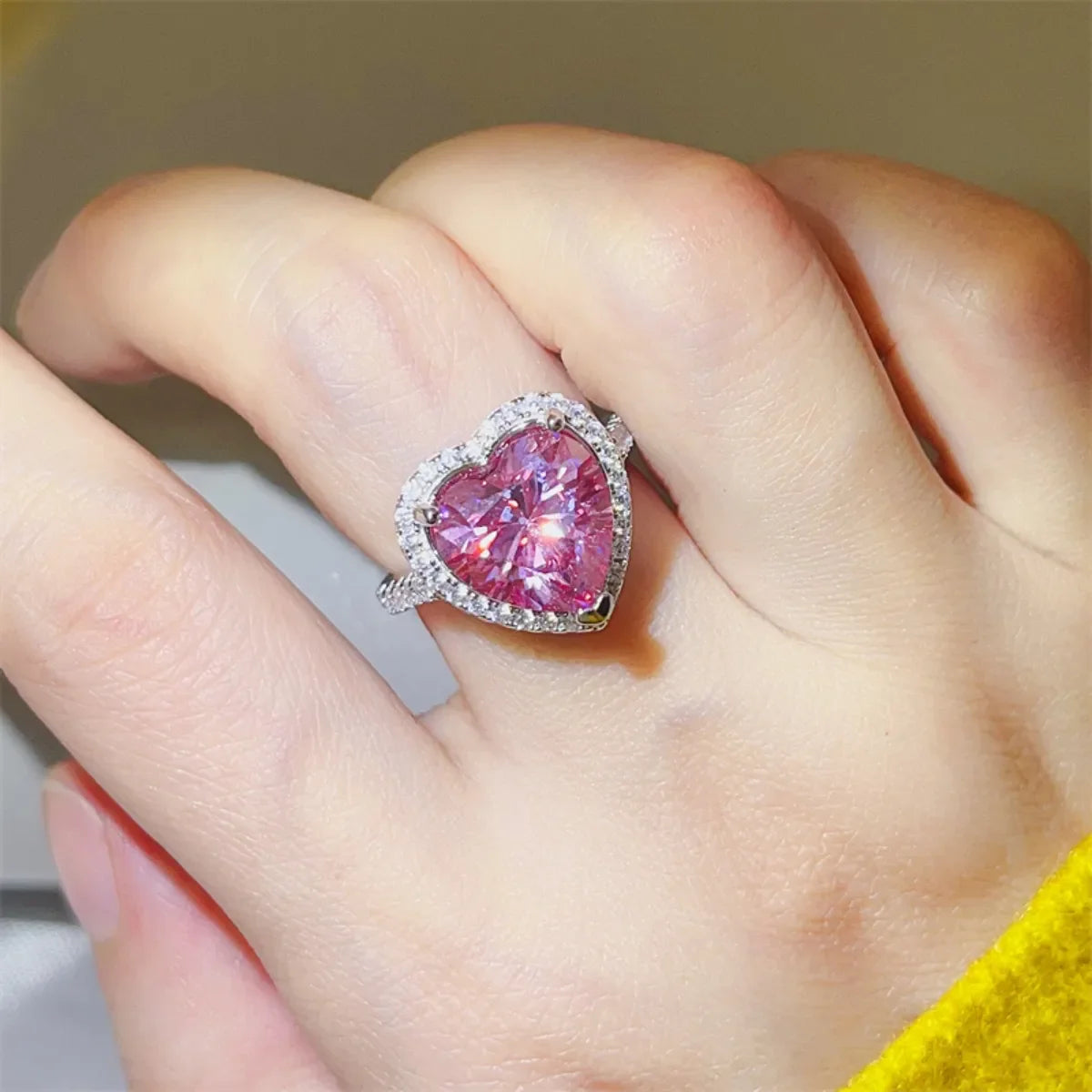 Fuchsia pink moissanite heart halo ring with diamond band.