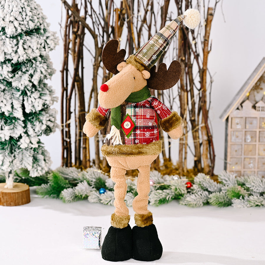 Reindeer Christmas decoration with plaid hat and sweater, green scarf, red nose.