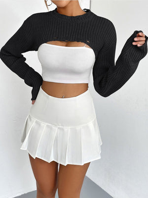 Black distressed knit bolero crop top with long sleeves and thumbholes, worn over a white tube top.