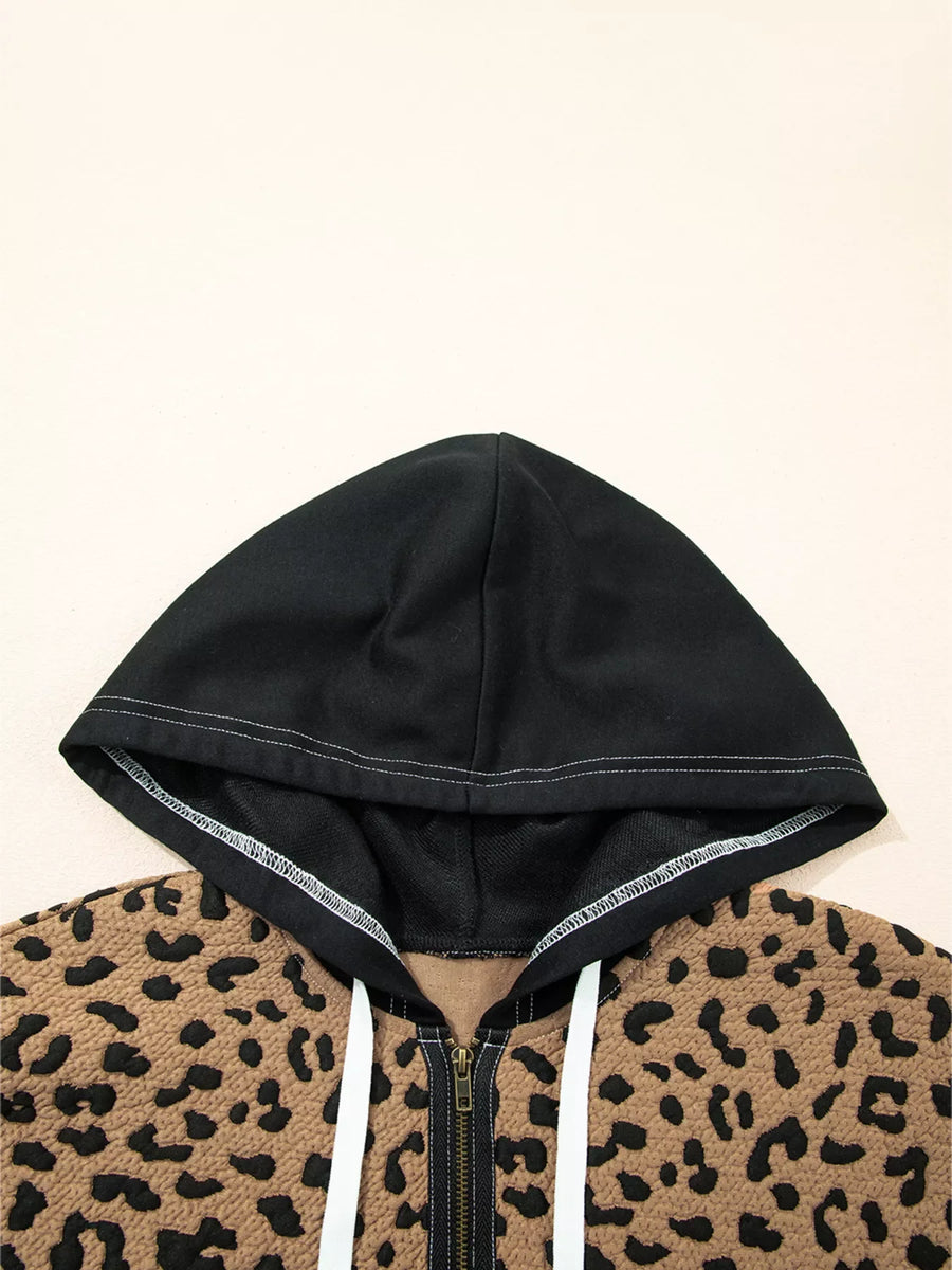 Zip front hoodie with leopard print and black hood, featuring white drawstrings.