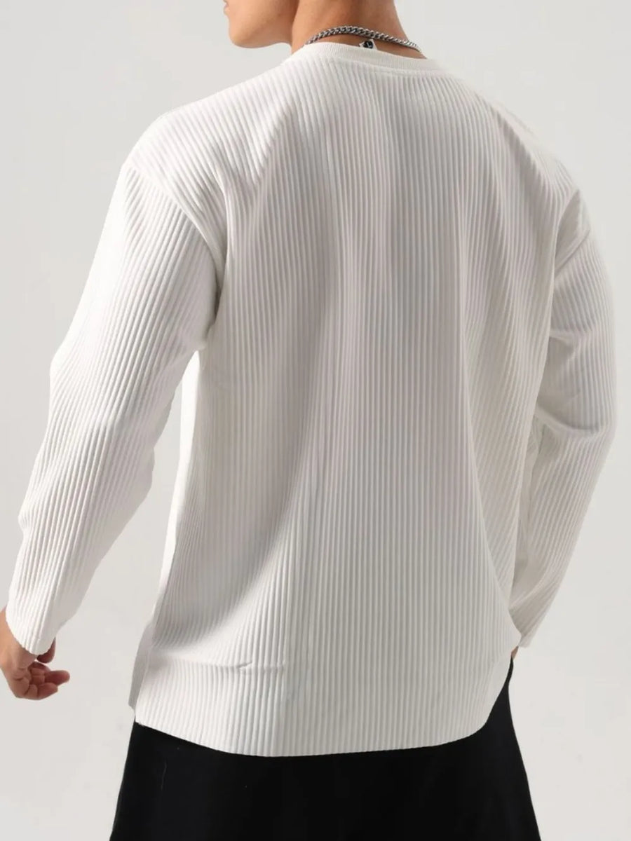 White textured plissé long sleeve henley top with a ribbed finish.