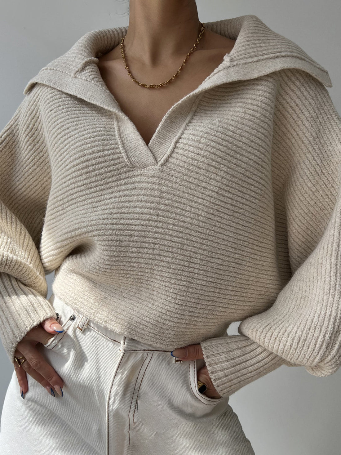 Wide collar balloon sleeve knit sweater in white with a v-neck and ribbed texture.