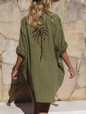 Green cotton blend button-down shirt dress with embroidered palm tree detail on back.