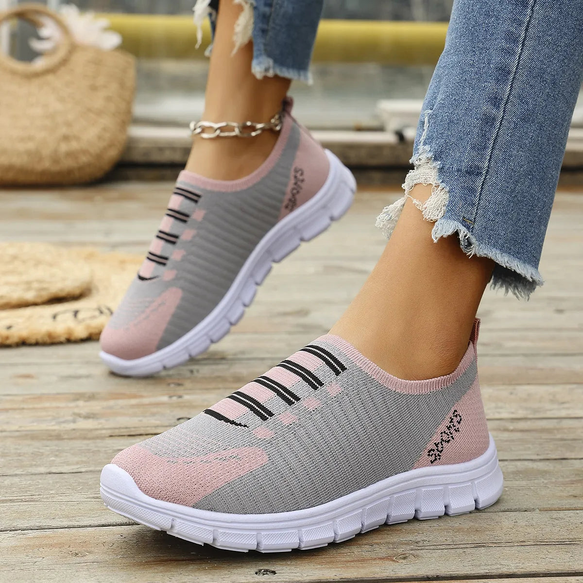 Ribbed knit slip-on sneakers in gray and dusty pink with black stripe detail.