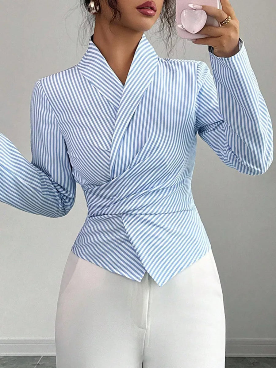 Striped long sleeve wrap blouse with a V-neck and cinched waist detail.
