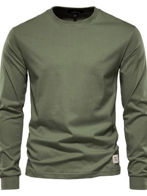Moss green crewneck long sleeve t-shirt with a small tag detail on the hem.