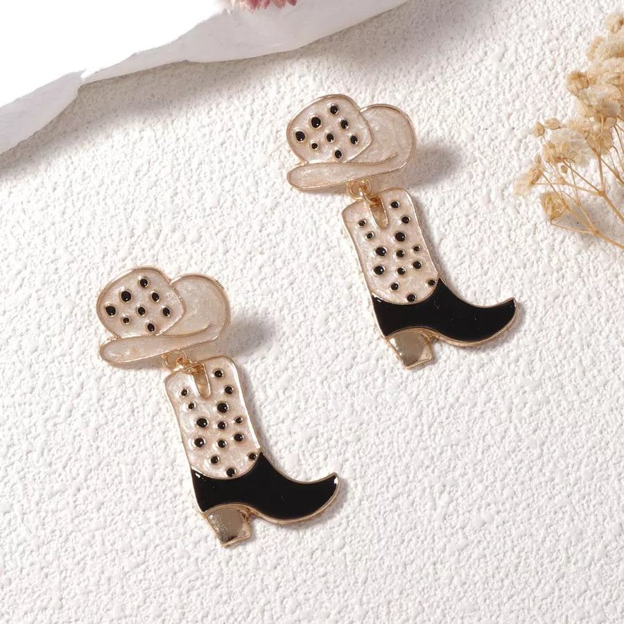 Western Charm dangle earrings with cowboy boot and hat design in white and black with gold accents.