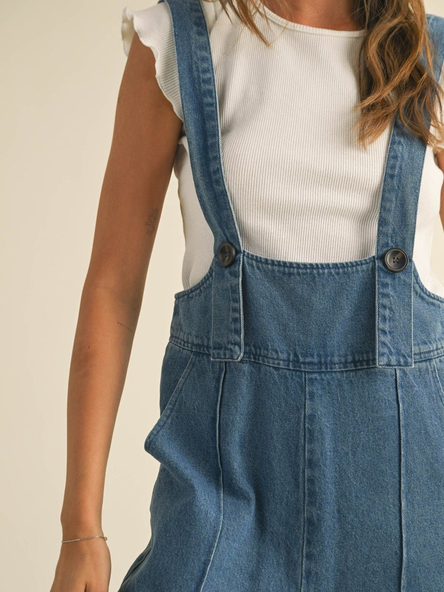 Vintage denim wide leg overalls with adjustable straps and button details.