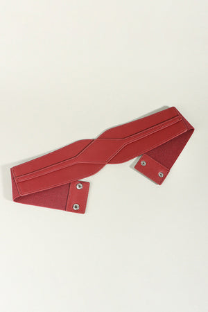 Red elastic belt with sculpted faux leather front and snap closure