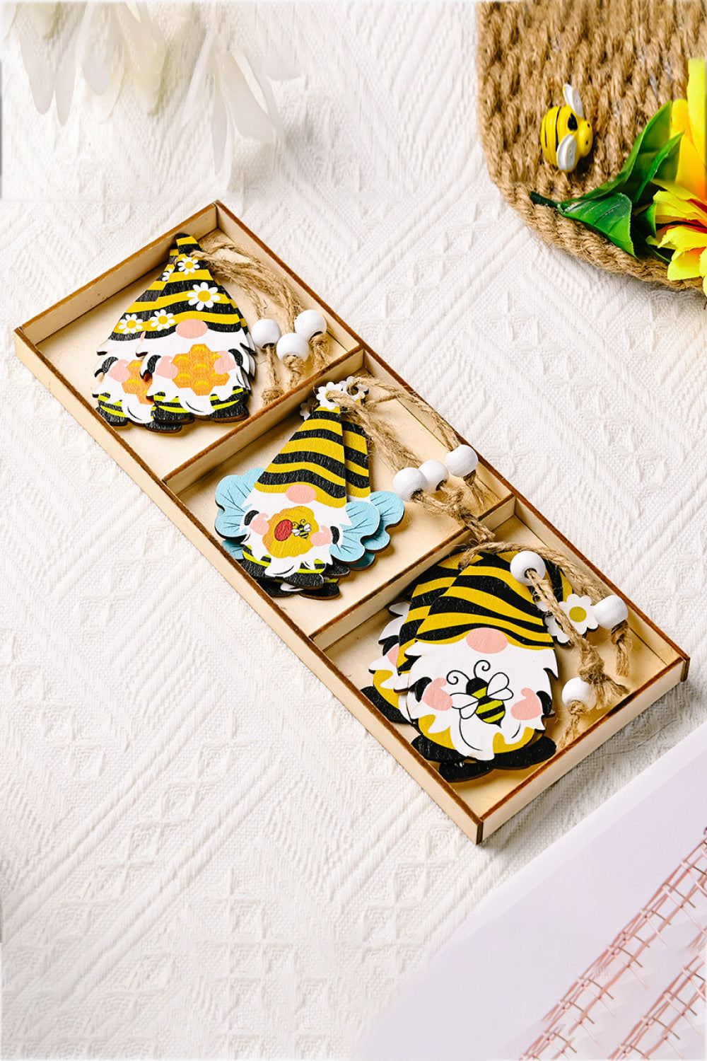 Set of 3 bee gnome ornaments in yellow and black stripes with floral accents and wooden beads.