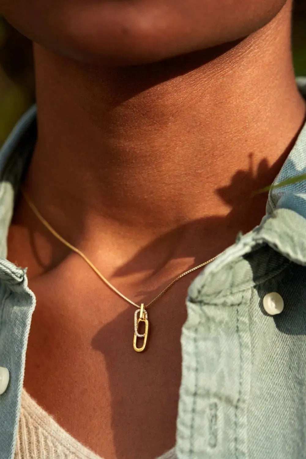 Gold linked zirconia pendant necklace with pave detail on a delicate chain.