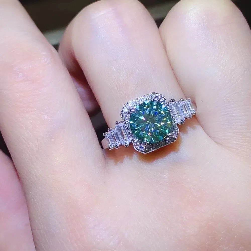 Emerald halo ring with baguette accents in silver.