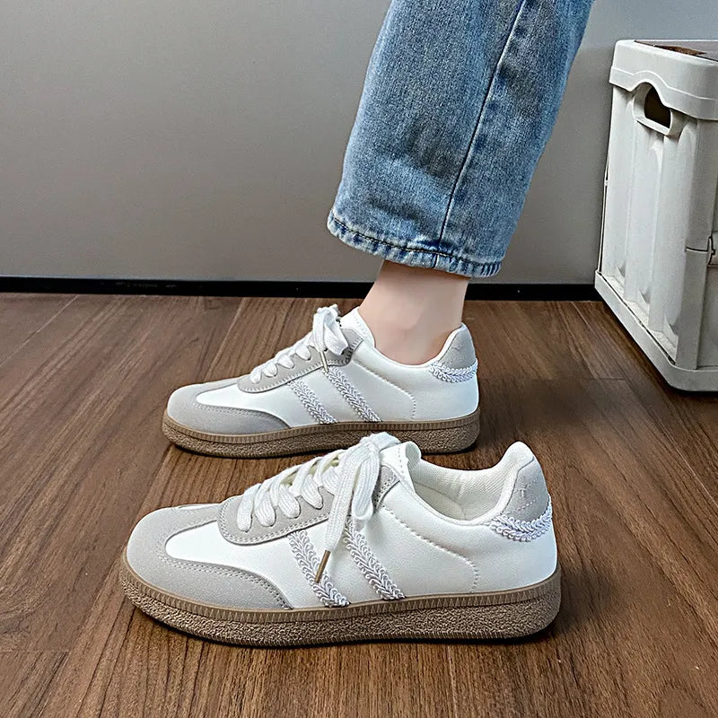 Retro panelled lace-up trainers in beige and white with grey suede accents and stitched detailing.