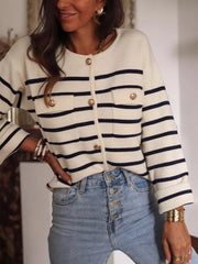 Navy and cream striped button-front cardigan with gold buttons and chest pockets.
