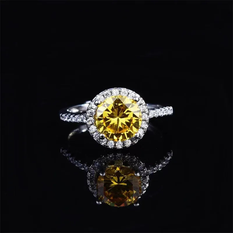 Halo-set canary diamond ring in silver with a round center stone and pave band.