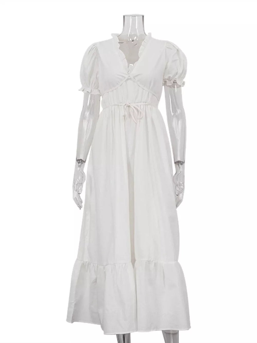 White tiered maxi dress with puff sleeves, ruffled neckline, and drawstring waist