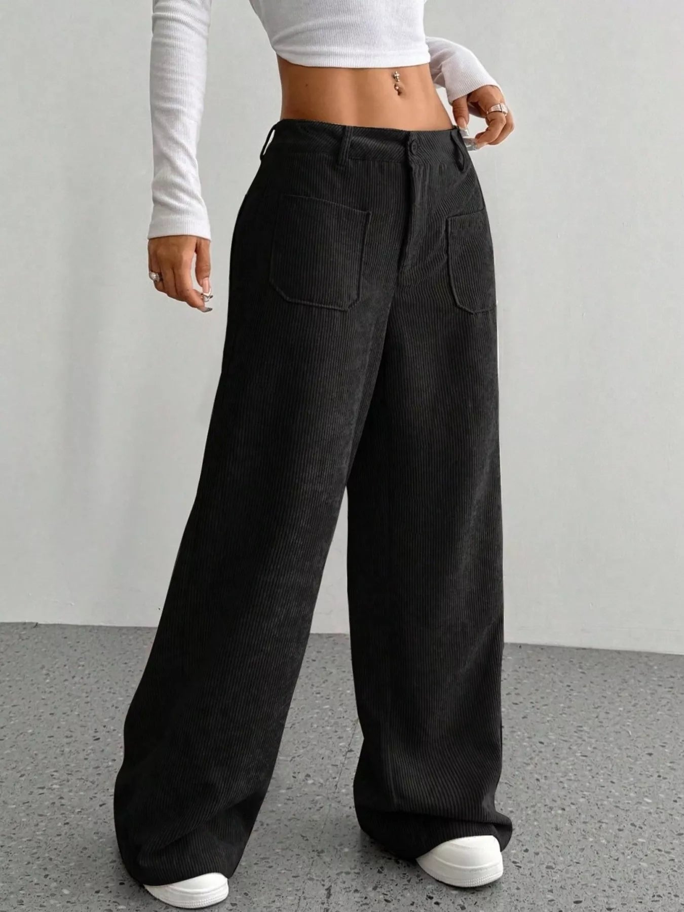 Black corduroy wide-leg trousers with front pockets and a comfortable fit.