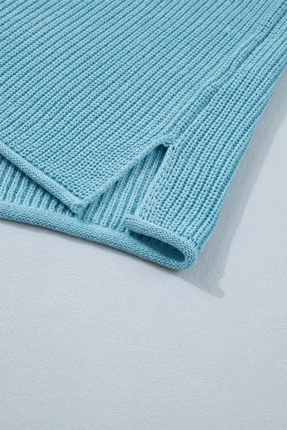 Relaxed blue ribbed knit sweater top with side slit detail