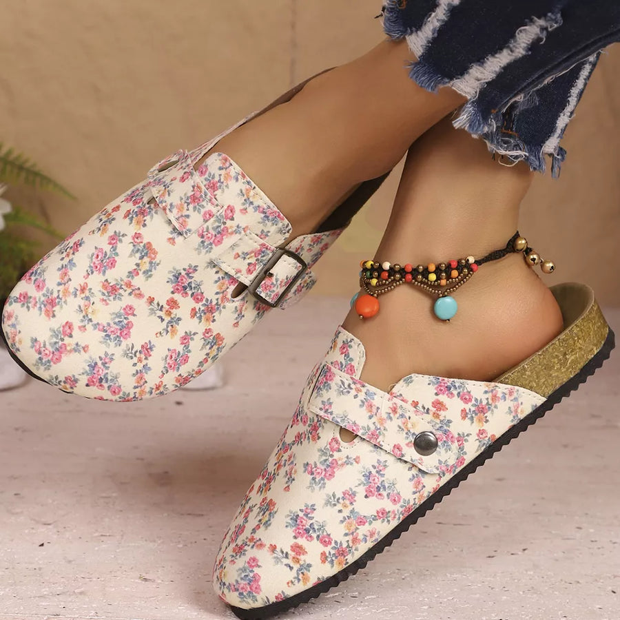 Floral print slip-on flats in beige with decorative buckle detail.