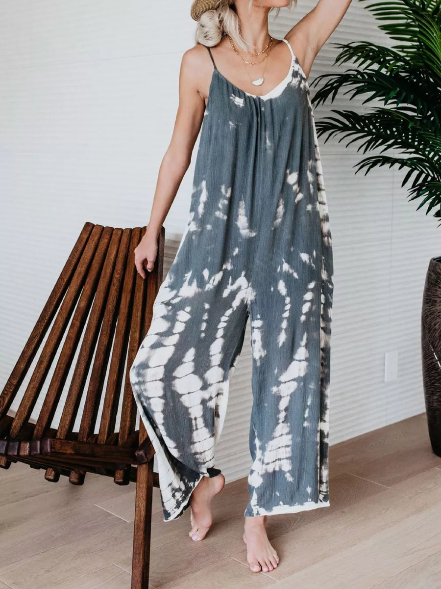 Jumpsuit with tie-dye pattern, spaghetti straps, wide leg, and gathered waist.